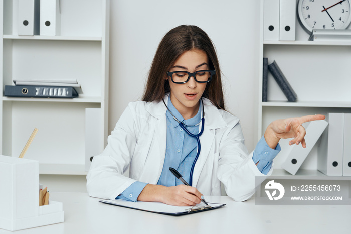 female doctor working on laptop in office