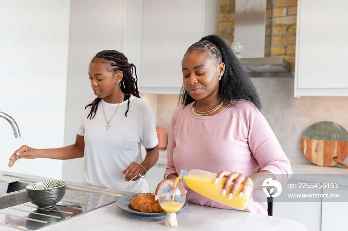 Lesbian couple preparing breakfast in kitchen