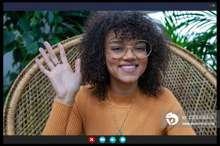 Smiling woman waving in video call