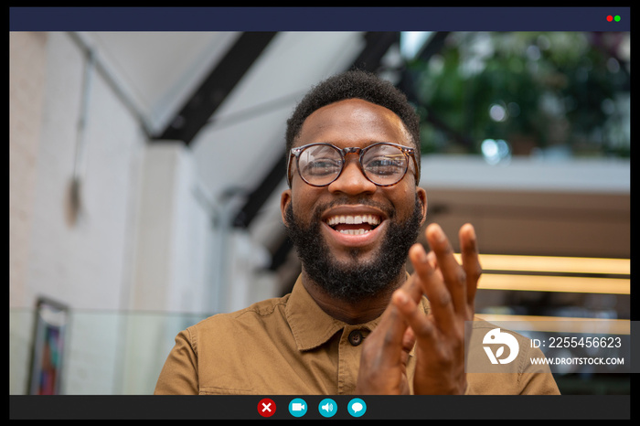 Smiling man clapping in video call