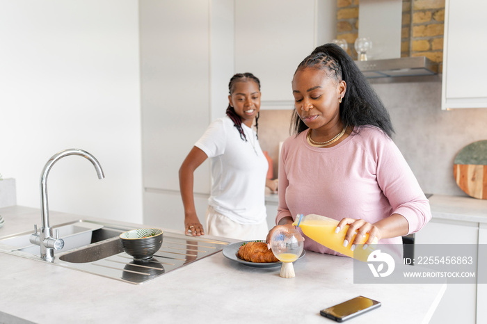 Lesbian couple preparing breakfast in kitchen