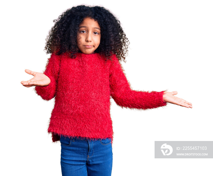 African american child with curly hair wearing casual winter sweater clueless and confused expression with arms and hands raised. doubt concept.