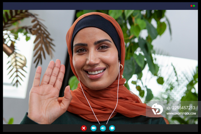 Smiling woman waving in video call