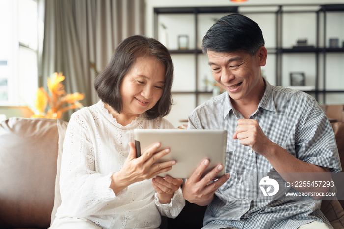 Scene couple of Asian elderly make a video conference call by smartphone during self isolation at home while covid19 epidemic.