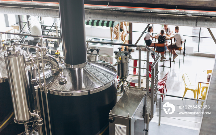 Wine making vats and equipment in tour of winery. Modern Beer Factory. Beer tasting in the Brewery