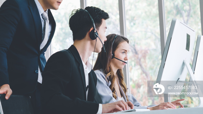 Business people wearing headset working in office to support remote customer or colleague. Call center, telemarketing, customer support agent provide service on telephone video conference call.