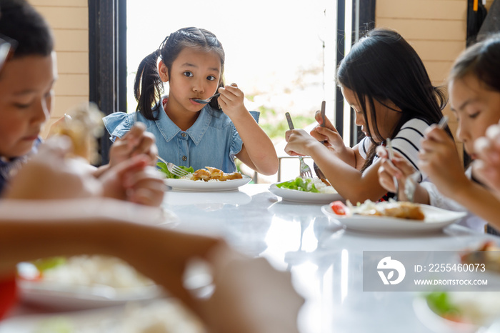 Group Of Children Eating Lunch In School