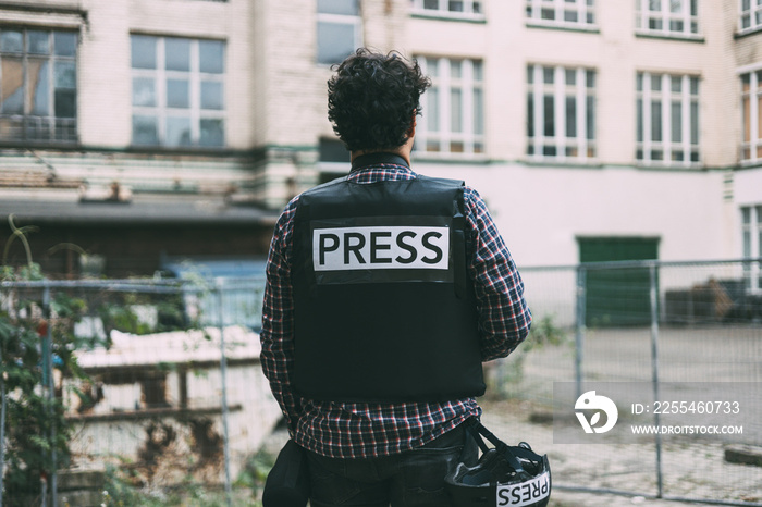 Photoreporter on his back with bulletproof vest