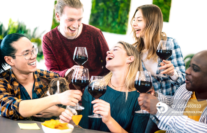 Young people toasting red wine at dinner party - Multiracial friends having fun together at restaurant winery bar - Happy hour life style concept