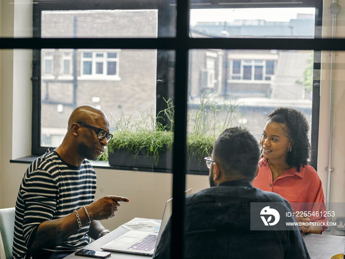 Colleagues talking at business meeting