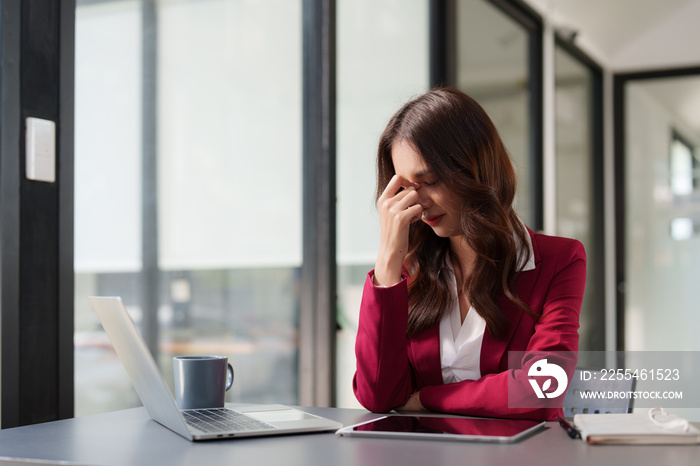 Stressed Business woman checking budget of company, taxes, bank account balance and calculating expenses at office