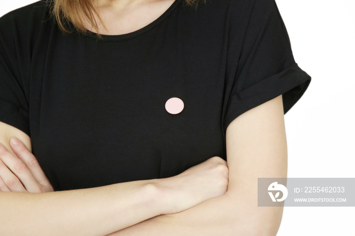 Small button badge pinned onto black shirt