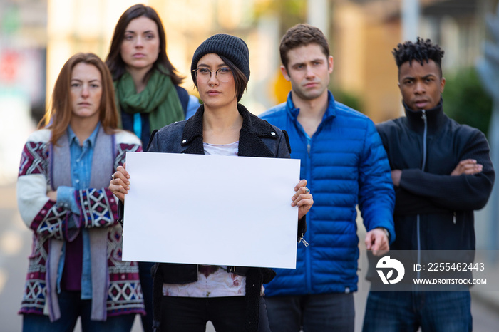 Group of protesters holding a blank sign during demonstration