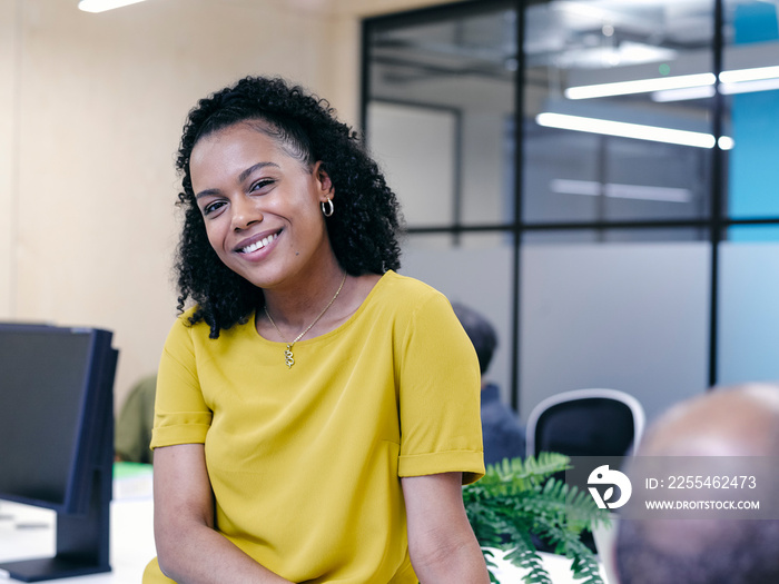 Portrait of woman in co-working office space