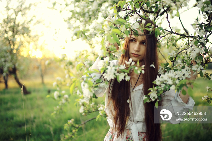 Cherry blossoming garden in spring beautiful adult young girl relaxing