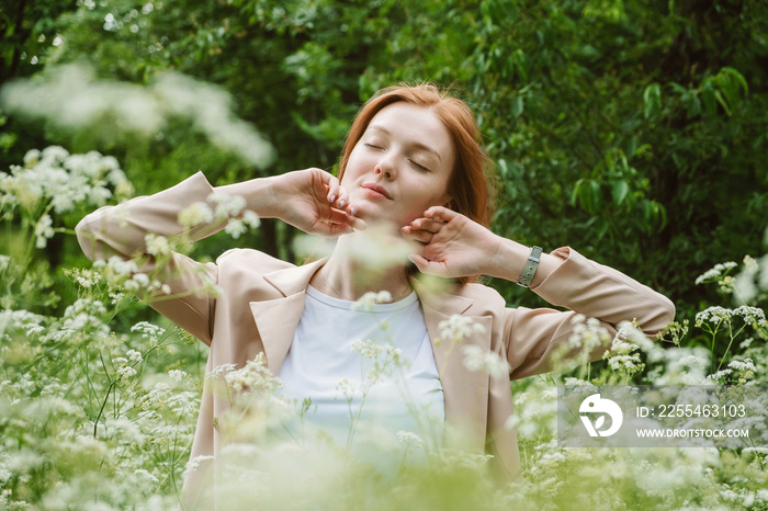 World mental health day, work-life balance, spread positive messages concept. Redhead woman in business suit enjoying nature