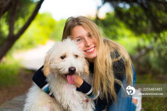 Young girl with her dog in a park