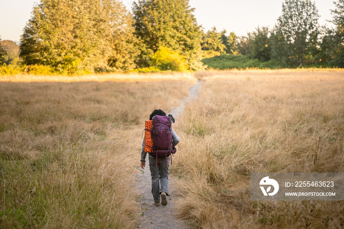 U.S. Army female soldier putting in the miles with an early morning hike in the NorthWest.