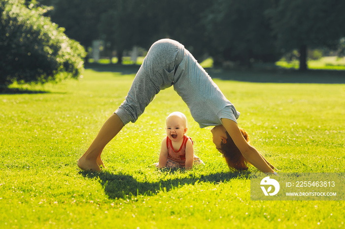 Woman doing yoga with baby in nature