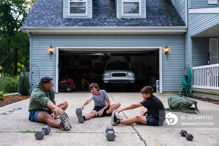 Air Force service member trains with his sons in a morning workout in preperation for a PT fitness test.