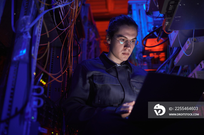 Young technician setting up internet network in server room