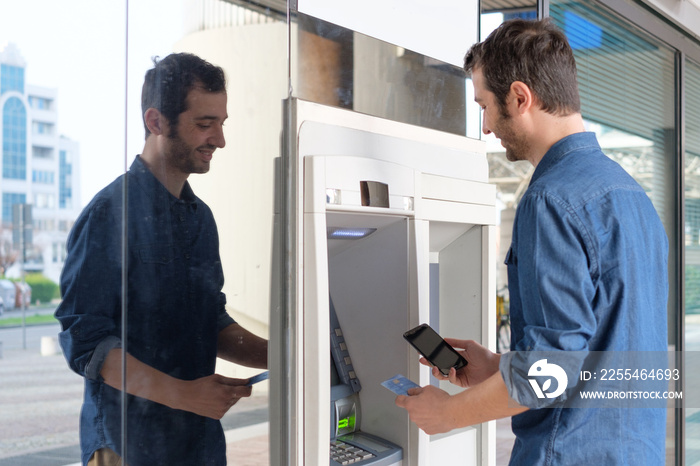 Man hand inserting a credit card in an atm