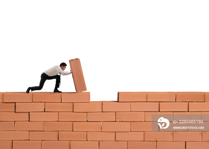 Businessman puts a brick to build a wall. Concept of new business, partnership, integration and startup