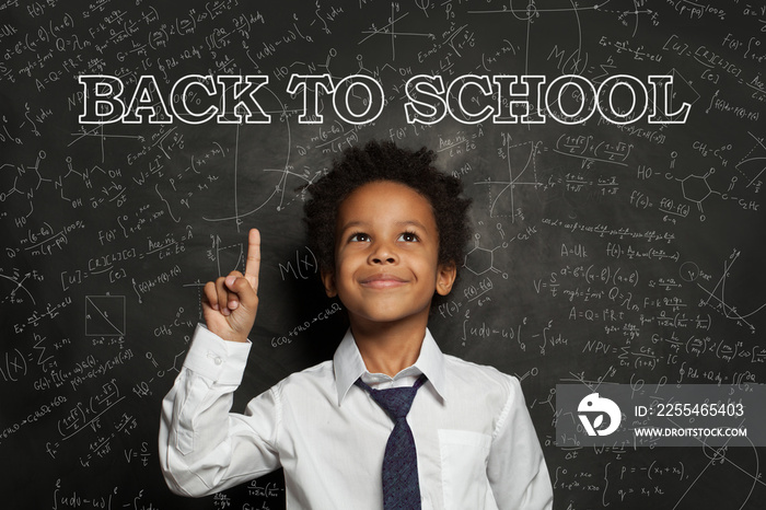 Happy successful African American child student boy smiling, back to school concept