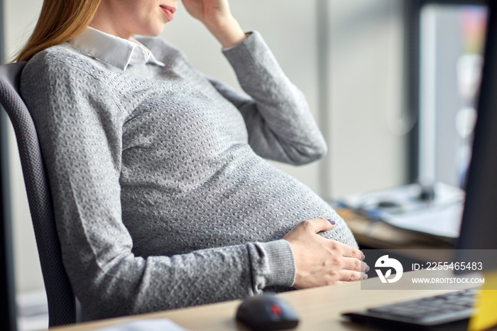 pregnant businesswoman sitting at office