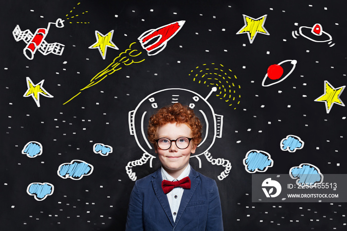 Little boy kid astronaut on blackboard background with space scetch