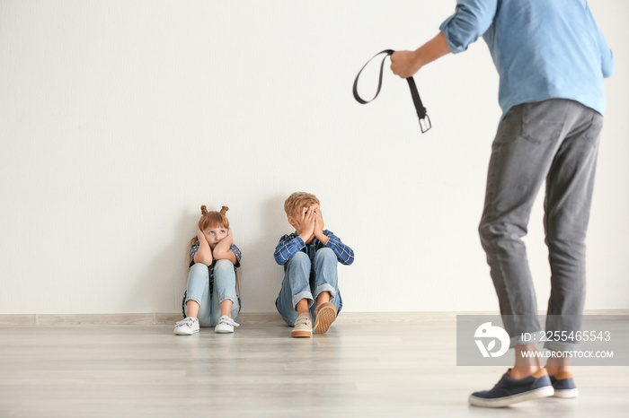 Man threatening his little children. Physical punishment concept