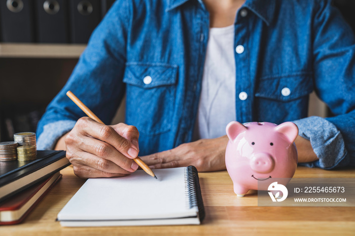 Business woman taking notes on income and expenses, saving for the future after retirement, saving ideas