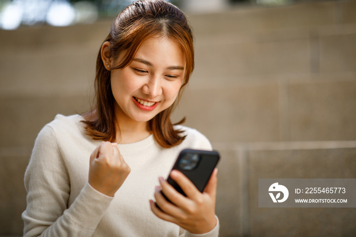 Portrait of young student girl, Excited student checking smartphone content in a campus,The study, education, university, college, graduate concept