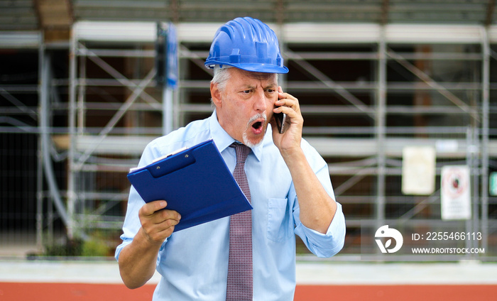 Angry senior engineer shouting at the phone