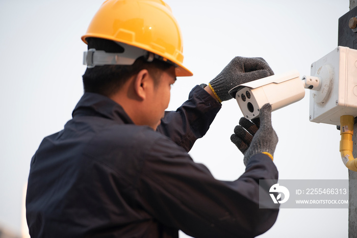 CCTV technicians install, maintain IP surveillance cameras outdoors for workplace safety.