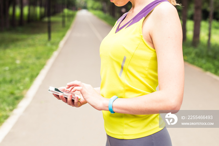 Woman checking fitness and health tracking wearable device