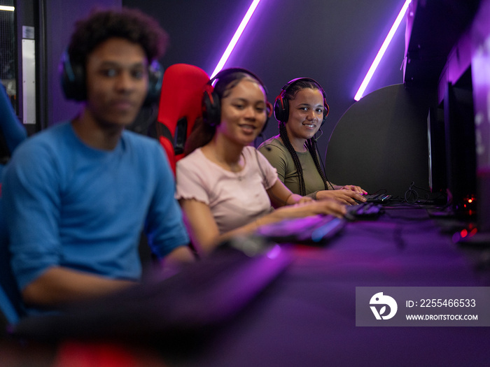 Portrait of friends playing video games in gaming club