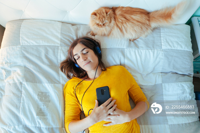 woman having a nap while using technology