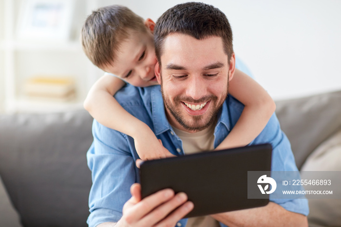 father and son with tablet pc playing at home