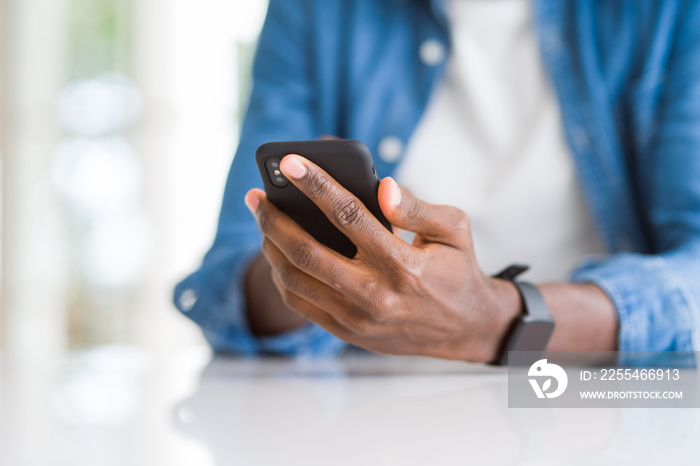 Close up of african man hands using smarpthone