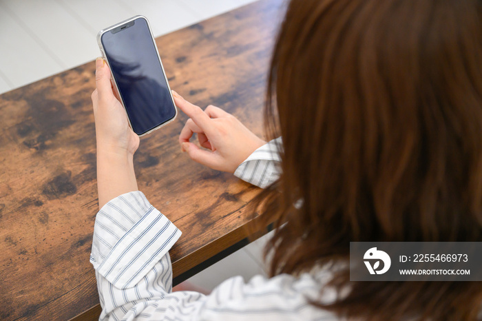 Woman’s hand looking at phone Screen for composite black