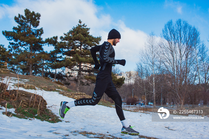 young runner training outdoor in winter park