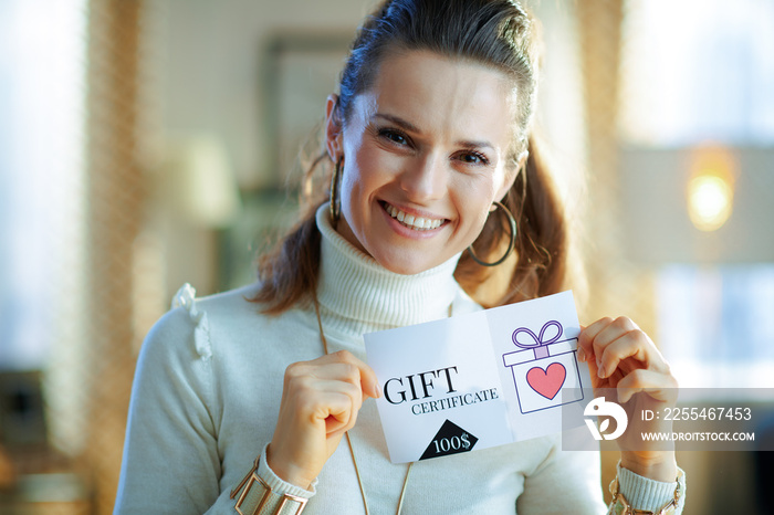 smiling middle age woman showing gift certificate