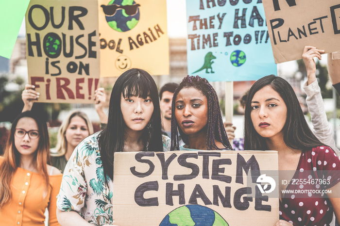 Group of demonstrators on road, young people from different culture and race fight for climate change - Global warming and enviroment concept - Main focus on afro girl face