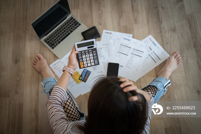 stressed woman trying money to pay credit card debt and many expenses bills such as electricity bill,water bill,internet bill,phone bill during covid-19 or coronavirus outbreak at home