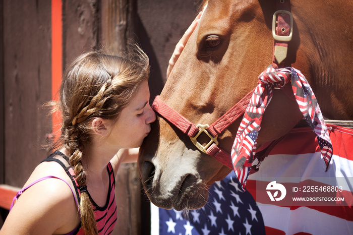 Girl kissing horse