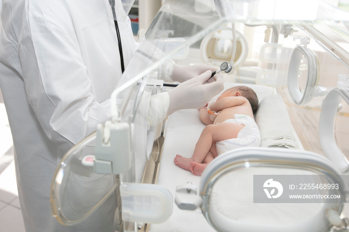 A newborn baby lies in boxes in the hospital. A child in an incubator. Neonatal and Premature Intensive Care Unit