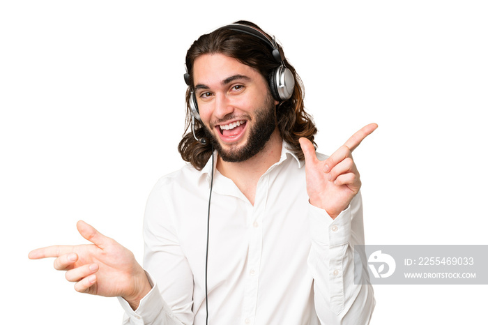 Telemarketer man working with a headset over isolated chroma key background pointing finger to the laterals and happy