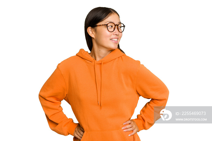 Young Asian woman isolated on green chroma background confident keeping hands on hips.