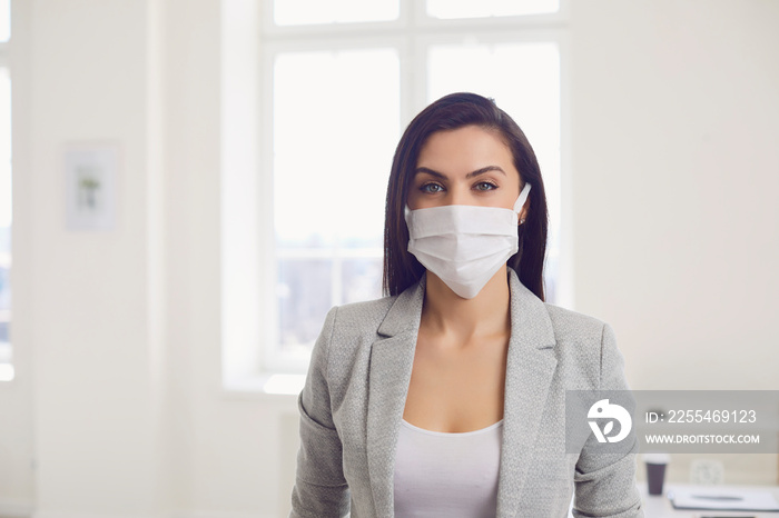 Danger of infection of the virus coronavirus infection. Businesswoman in medical mask at office